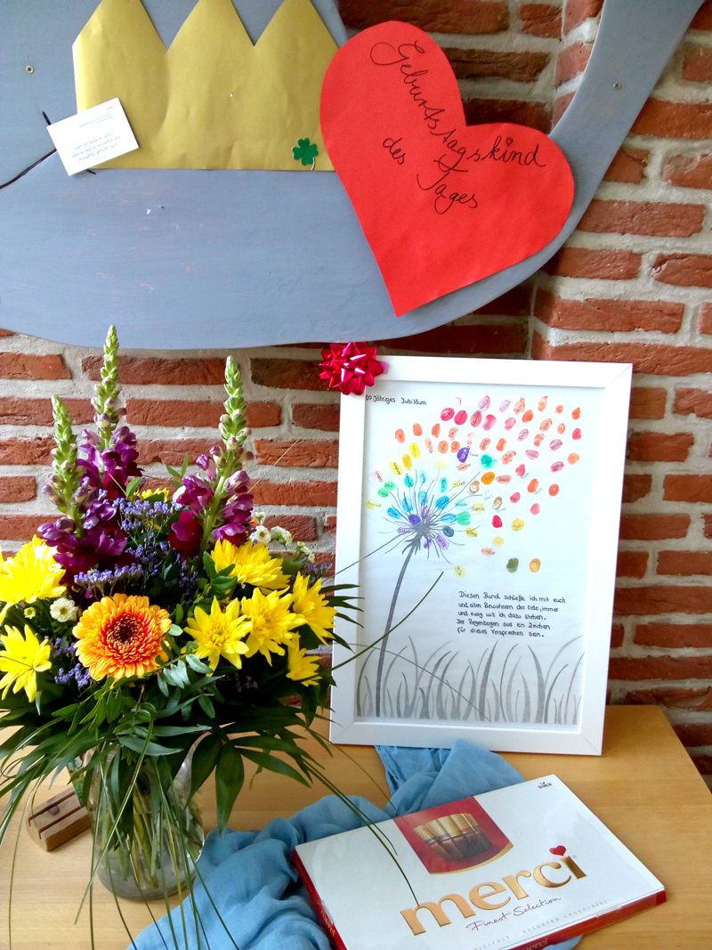 Blumenstrauß und Fingerabdruckbild auf Tisch